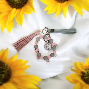 Let all that you do be with love keychain baraclete in pink