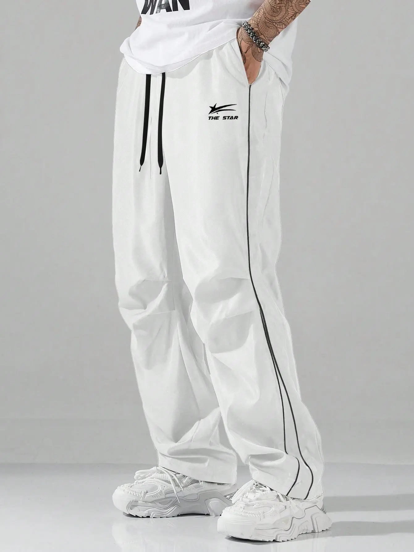 Men’s all-season casual pants featuring trendy letter and stripe designs, suitable for everyday wear and versatile for outdoor activities.