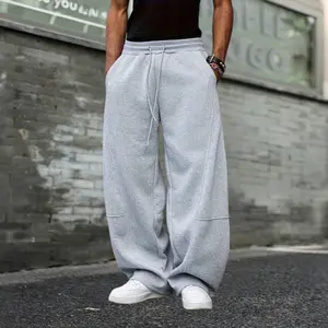 Gray curved hem wide leg sweatpants with a relaxed American street style. Made from heavyweight cotton that resists pilling and doesn’t cling to the legs. Features an avant garde deconstructed patchwork cut with excellent drape. Slimming and figure flatte