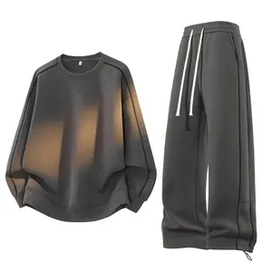 Men’s dark gray two-piece set featuring a loose crewneck long-sleeve sweatshirt and wide-leg jogger pants with contrast trim, drawstring, and minimalist design—casual and versatile loungewear for everyday wear.