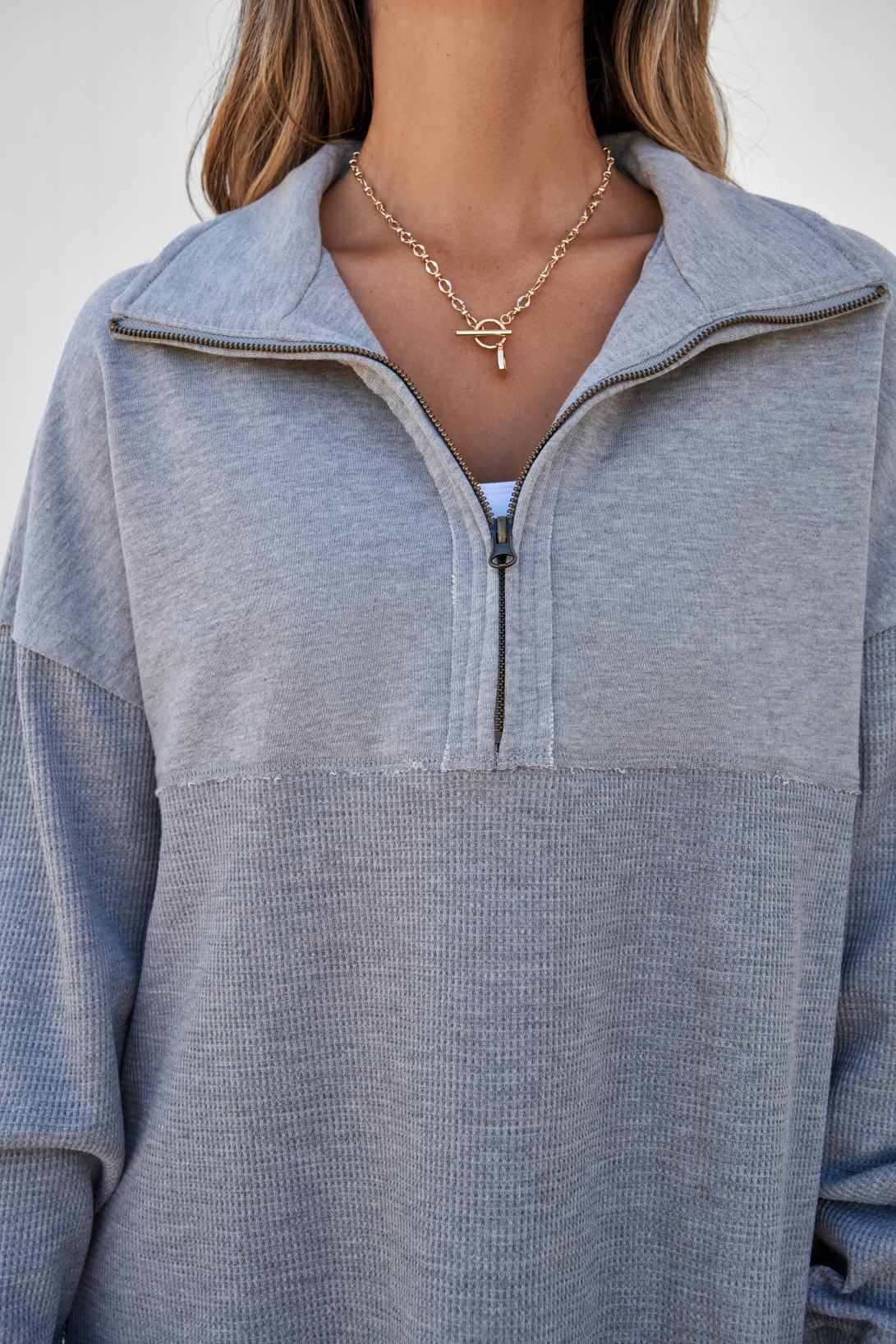 Woman wearing oversized half zip pullover