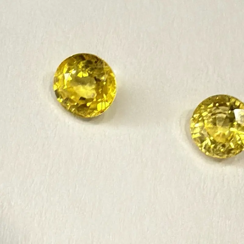 Pair yellow natural sapphires 1 carat. Heated mined sapphire round cut. Not a perfect pair but pretty close.