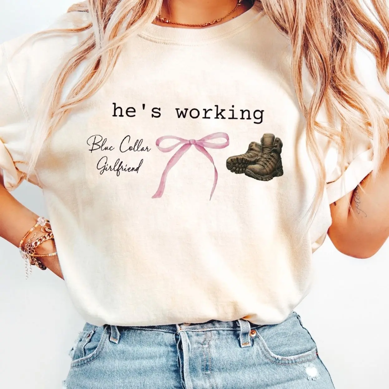 He’s Working Coquette Shirt – Carpenter, Welder, Lineman, Machinist & Mechanic Tee, Blue Collar Girlfriend Graphic Shirt, “He is Working” Casual Top