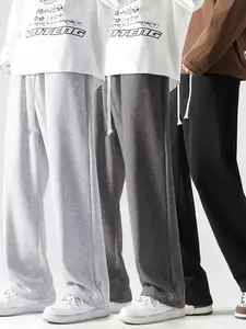 A men’s wide leg drawstring pants, urban casual style. The drawstring waist paired with a white cord knot adds a refined touch. The wide leg cut is relaxed and unrestrictive, with a fabric that drapes well and resists creasing. Suitable for city men after