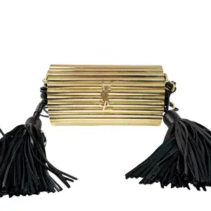 Pre-owned Yves Saint Laurent Gold-tone metal with black leather tassels Crossbody Bags Saint Laurent Cylinder Tassel Clutch in gold tone metal with black leather tassels.gh255#