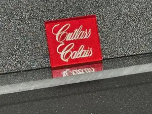 Oldsmobile Cutlass Calais Trunk Lock Cover Insert Emblem Reproduction Red Metallic and Chrome