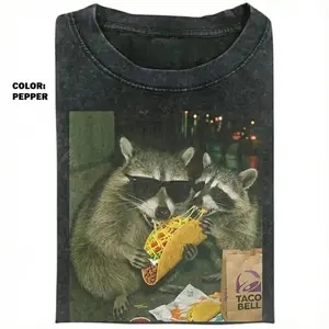 Comfort Colors Raccoon Eating Taco T-Shirt featuring a funny meme graphic, silly animal humor design, vintage retro unisex cotton top and cute gift for men and women alike.