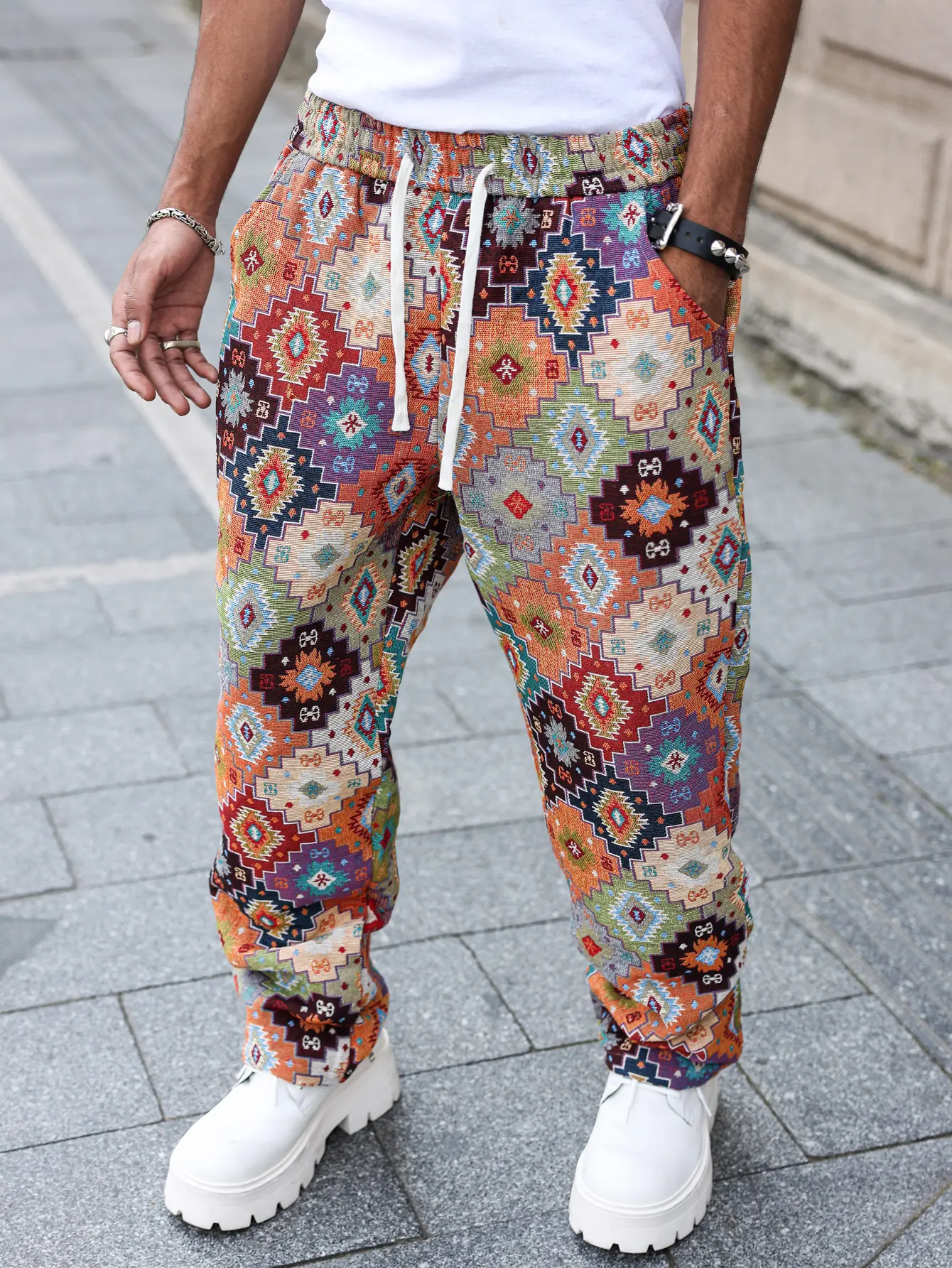 Men’s youth ethnic-style jacquard long pants with colorful geometric print and drawstring design—eye-catching for young men going out or on dates