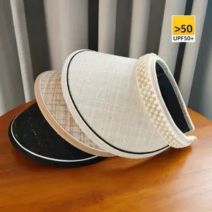 Wide-brimmed black vinyl sun hat with pearl headband, high-end and elegant visor for women.