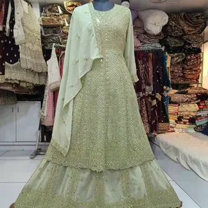 Light green in size 44 heavy Embroidered Wedding Lehenga Choli for bridal dress features intricate embroidery, mirror work, and stone embellishments on net fabric, often described as a readymade