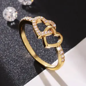 This minimalist women's ring, plated in 14k gold, is elegant and romantic, featuring interlocking hearts and a Zirconia stone, making it the perfect Valentine's Day gift.