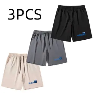 Men’s shorts with three-letter embroidery, featuring a casual minimalist style. A drawstring waistband allows for adjustable tightness, while blue letter embroidery on the sides adds a trendy touch. The smooth, drapey fabric resists wrinkles, and the loos
