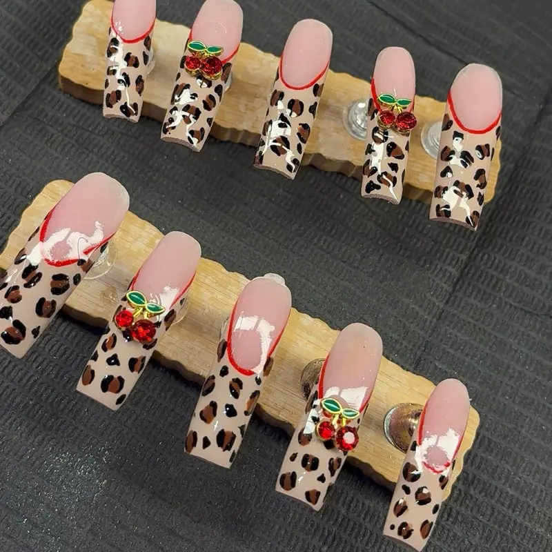 Sexy Cheetah Print Nails with Red Accents and Green Leaves for a Bold Look